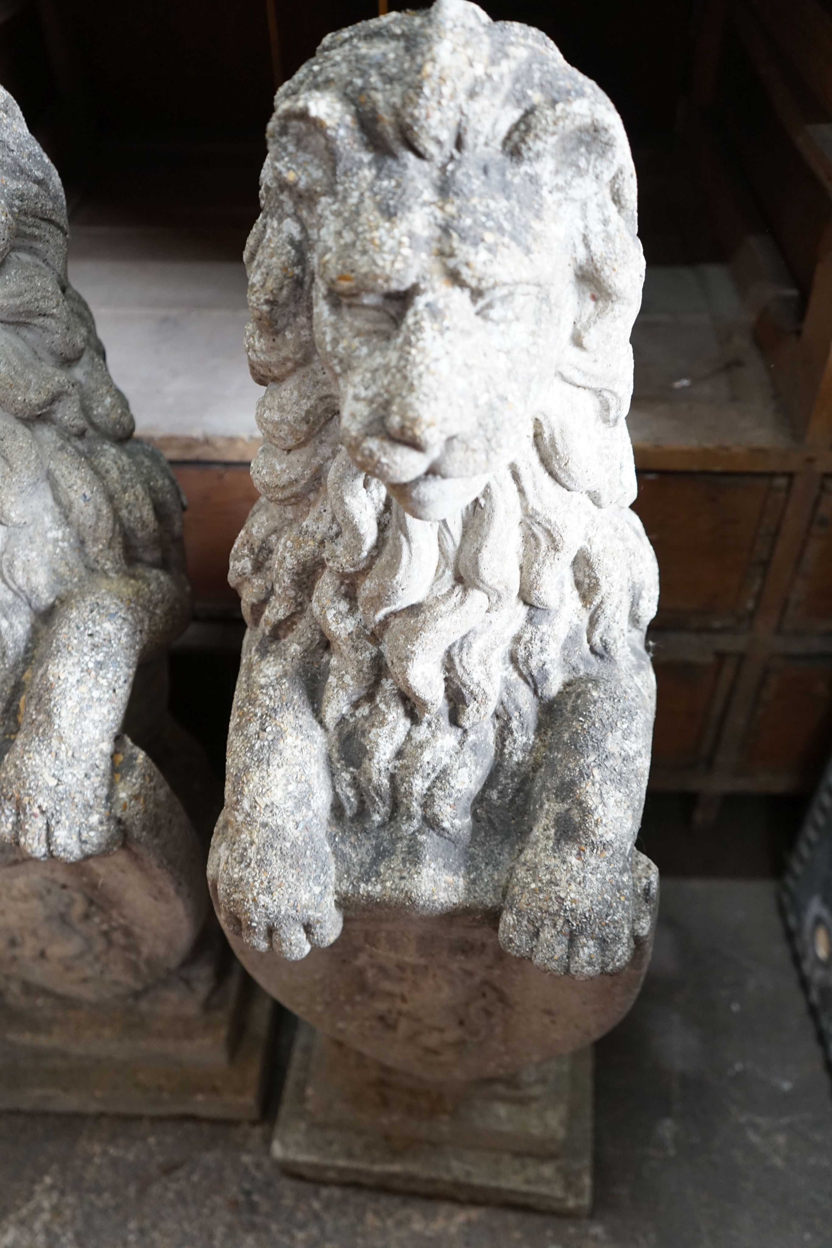 A pair of reconstituted stone heraldic lions, height 80cm